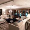 a living room with a chandelier and glass door