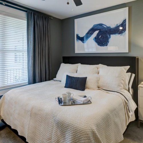 a bedroom with a fan and a bed