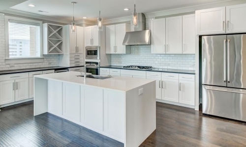 Spacious kitchens with thoughtful details a kitchen with white cabinets