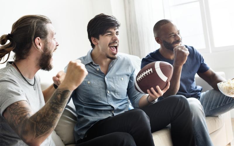 a group of people sitting on a couch with a football