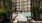a courtyard with a pool and buildings